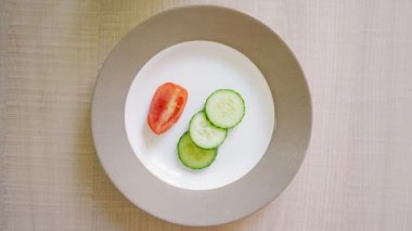Pov, Male Hand with a Fork Eats Cucumbers and Tomatoes from a Plate. Concept of Vegetarianism and Diet for Weight Loss. Unrecognizable Person, Close-up, Top Veiw.