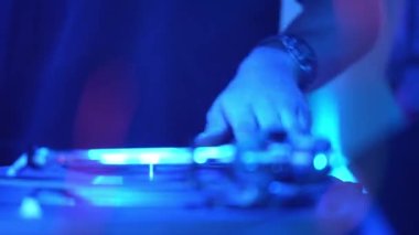 DJ, gece kulübü partisinde DJ konsolunda şarkı karıştırıyor. Gece kulübü disko partisinde DJ Mixer Controller masası. Eller düğmelere basıyor ve sürgüler Elektronik Müzik Çalıyor
