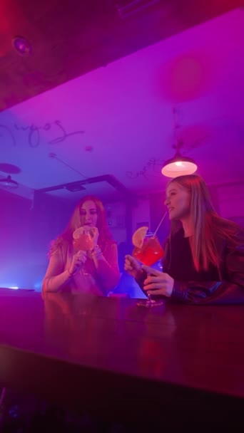 Two Happy Women Friends Talking Night Bar Neon Lighting Drinking — Stock Video