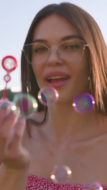 Retrato Feliz Morena Mulher Vestindo Óculos Soprando Bolhas Sabão Primavera — Vídeo de Stock