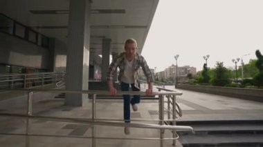 Gömlekli Genç Yetişkin Adam Akrobatik Dublörleri ve Parkour 'u Kullanarak Engellerin Üstesinden Geldi. Başarı ve Başarı. Gençlik Kültürü ve Halk Konsepti. Yavaş Hareket