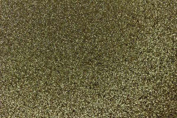 Gold color macro sparkling glitter texture background with vibrant color