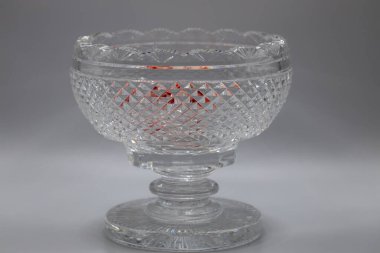 Macro view of a beautiful vintage lead crystal glass footed centerpiece bowl with diamond cuts and scalloped edge
