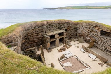 Close up view of an ancient dwelling in Skara Brae, a well preserved 5,000 year-old Neolithic village settlement on mainland Orkney Island in northern Scotland clipart