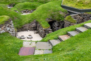 Landscape view of Skara Brae, a well preserved 5,000 year-old Neolithic village settlement on mainland Orkney Island in northern Scotland clipart