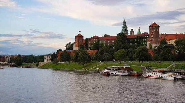 Beautiful old royal Wawel Castle on the banks of Vistula river in the evening. The main historical landmark of Krakow, a popular tourist destination in Poland.Old town, place for vacation and travel