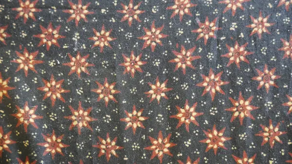 Close up of a colorful batik cloth pattern on black background.. Thai silk fabric pattern, Thai silk fabric pattern background.