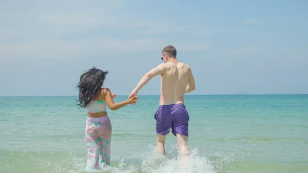 방학에 부부들은 해변을 미소짓고 휴가를 즐기죠 — 스톡 사진