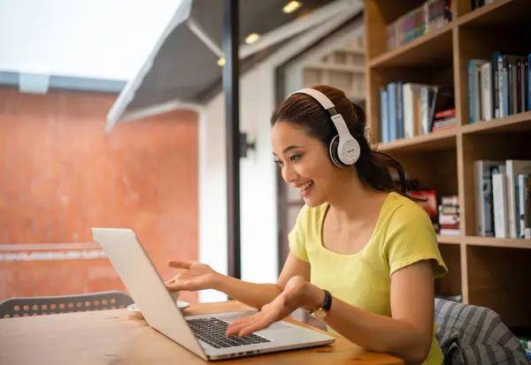 stock image Young woman having video call via computer in the home office.Business video conferencing.