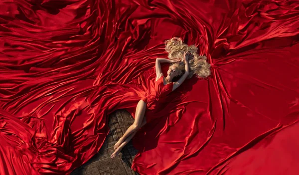 Красива Жінка Ідеальними Ногами Лежить Гігантській Червоній Сукні Яка Покривала — стокове фото