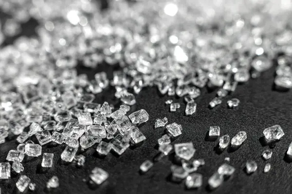 Sugar micro crystals shooted on a black - macro photo abstract background
