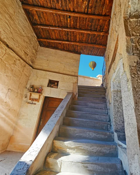 Upstairs to the light. Stone stairs to the open air, freedom and light with flying balloon. Cappadocia architecture. Conceptual photo about freedom and hope.