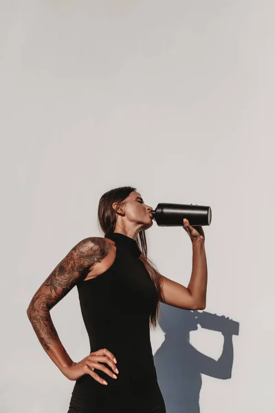 Beautiful Young Fit Tanned Caucasian Woman Tattoo Drinking Protein Shake Royalty Free Stock Images