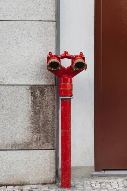 Red standpipe fire hydrant on the wall clipart