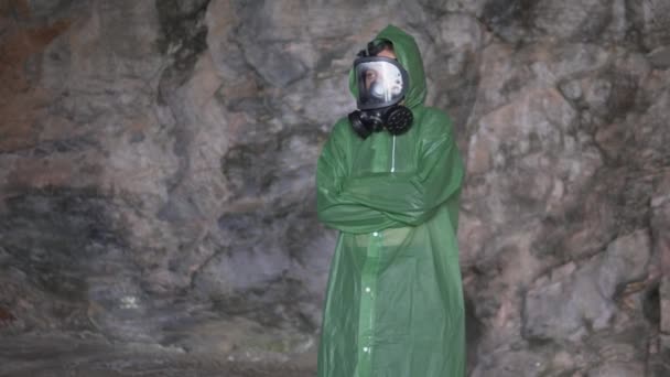 一个身披防毒面具的惊慌失措的女人躲在山洞里 — 图库视频影像