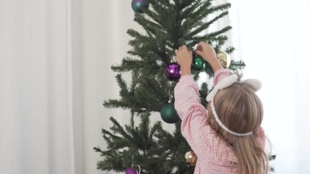 View Back Baby Hangs Ball Christmas Tree — Stock Video