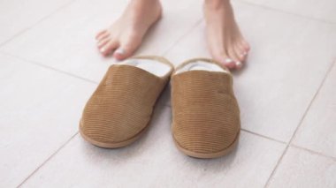 Bacaklarını kapatıyordu, bir kadın kürk terliklerini giydi ve gitti..