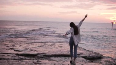 Güzel günbatımı videosu. Kışın deniz kenarında gün batımında genç bir kadın kavramı, Türkiye ve Alanya