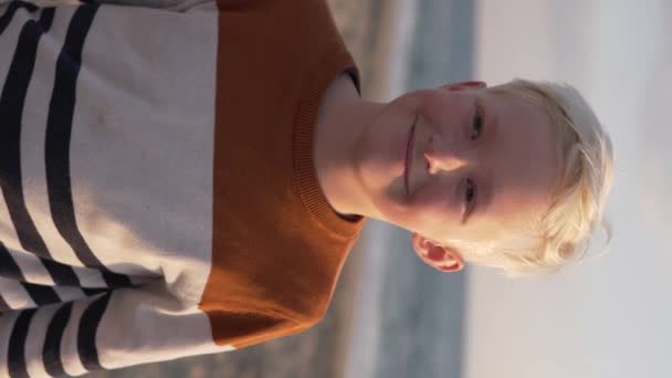 Close Blond Boy Adjusts His Hair Shows Heart His Fingers — Video Stock