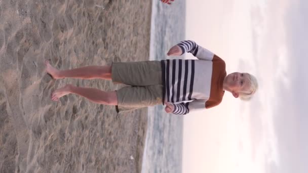 Blonde Boy Dances Popular Dance Beach Sea Vertical Video — Stockvideo