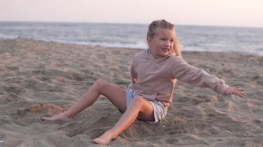 A little girl plays sand on the beach. Turkey, Alanya, winter