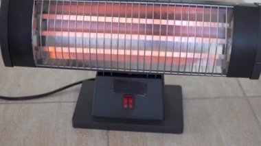 A womans hand turns off the electric battery at the touch of a button.
