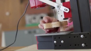 A child makes a wooden toy on a loom in a labor lesson at school.