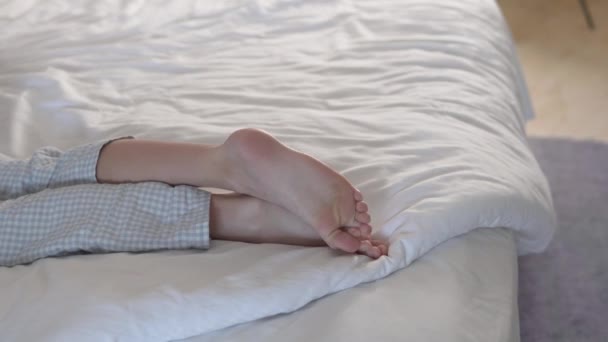 Boys Light Feet Lie White Linen Bed — Stock Video