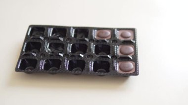 A womans hand returns the ode to the chocolate candy in the package.