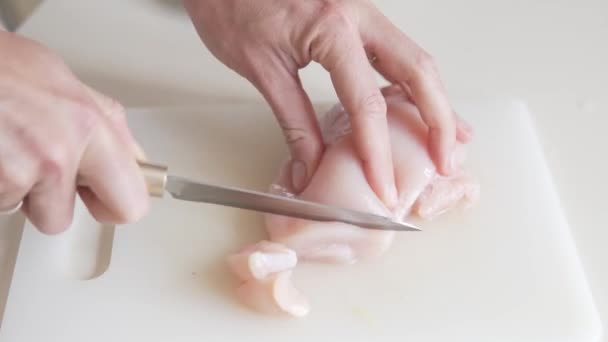 女性の手はナイフでまな板の上に鶏の切り身を切断 — ストック動画