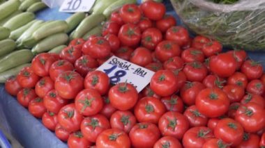 The buyer chooses tomatoes at a farmers market in Turkey. Alanya