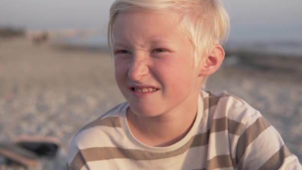 Close Handsome Blond Boy Squinting Setting Sun Beach — Stock video
