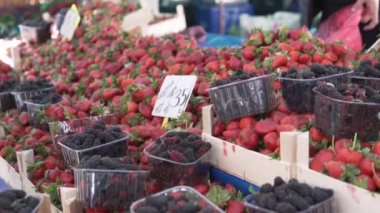 A person buys berries at a farmers market in Turkey, Alanya.