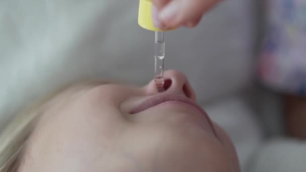 Close Woman Instills Drops Nose Little Girl — Stock Video
