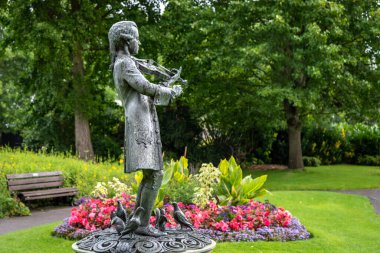 Young Mozart statue located in Parade Garden in Bath UK clipart