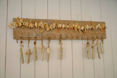 Duvarında tahta bir tahtanın üzerinde asılı numaralar ve anahtarlar. Tatil köyü, otel, sahil kulübü 