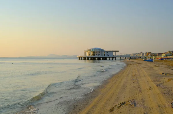 stock image Rotonda al mare during sunrise across the sky, sea, and coastline across the horizon in Senigallia, Italy. Postcard. Modern architecture