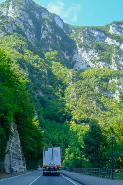 picturesque mountain road in the mountains, truck moving on the highway. Genga, Marche, Italy. The Appennines