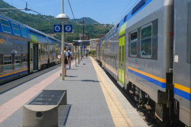 Haziran 2023 La Spezia, İtalya: Tren istasyonu, bavullu ve hızlı trenli yolcular dağları aşıyor 