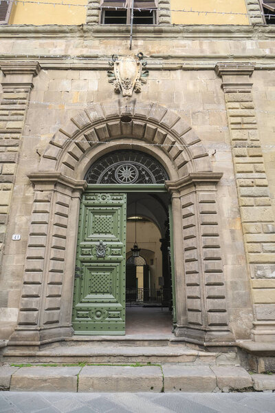 Вход в Confindustria Тоскана Норд, место Лукка. красиво оформленные старинные зеленые деревянные двери 