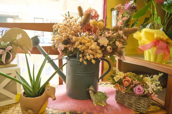 bouquet of dry flowers in pastel colors in an old blue iron watering can inside. Autumn bouquet. Fall Card