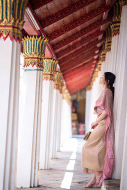 Beautiful Asian girl in Thai traditional costume at temple