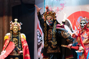 Chinese actor performs a public traditional changing face performance onstage in Chengdu, China clipart