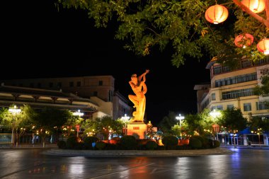 DUNHUANG, CHINA - OCT 20, 2024: Night view of flying Apsara statue in the center city of Dunhuang, Gansu, China clipart