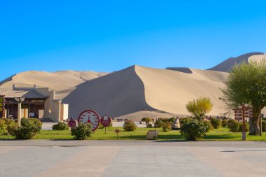 Dunhuang,China-OCT 21 2024- Mingsha Shan, also known as Echoing Sand Mountain, is a desert landscape located in Dunhuang city, China clipart