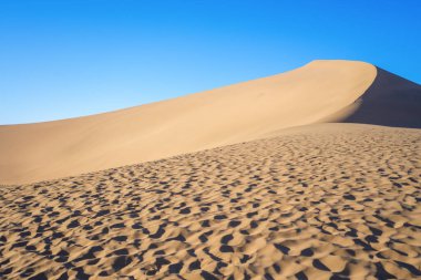 The landscape of desert against blue sky clipart