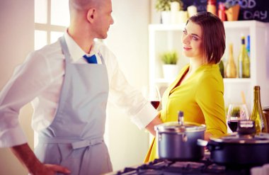 Aşık çekici bir çift yemek pişirir ve onlar romantik bir akşam yemeği pişirirken mutfakta şarap açar..