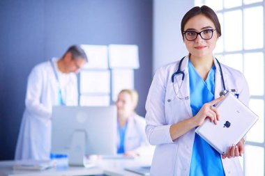 Hastane lobisinde tablet bilgisayar kullanan kadın doktor.,