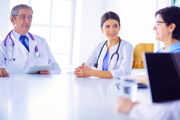 stock image Serious medical team using a laptop in a bright office