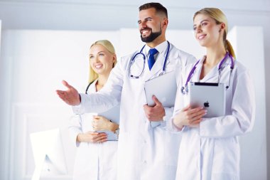 Meslektaşının önünde el sıkışan erkek doktor.